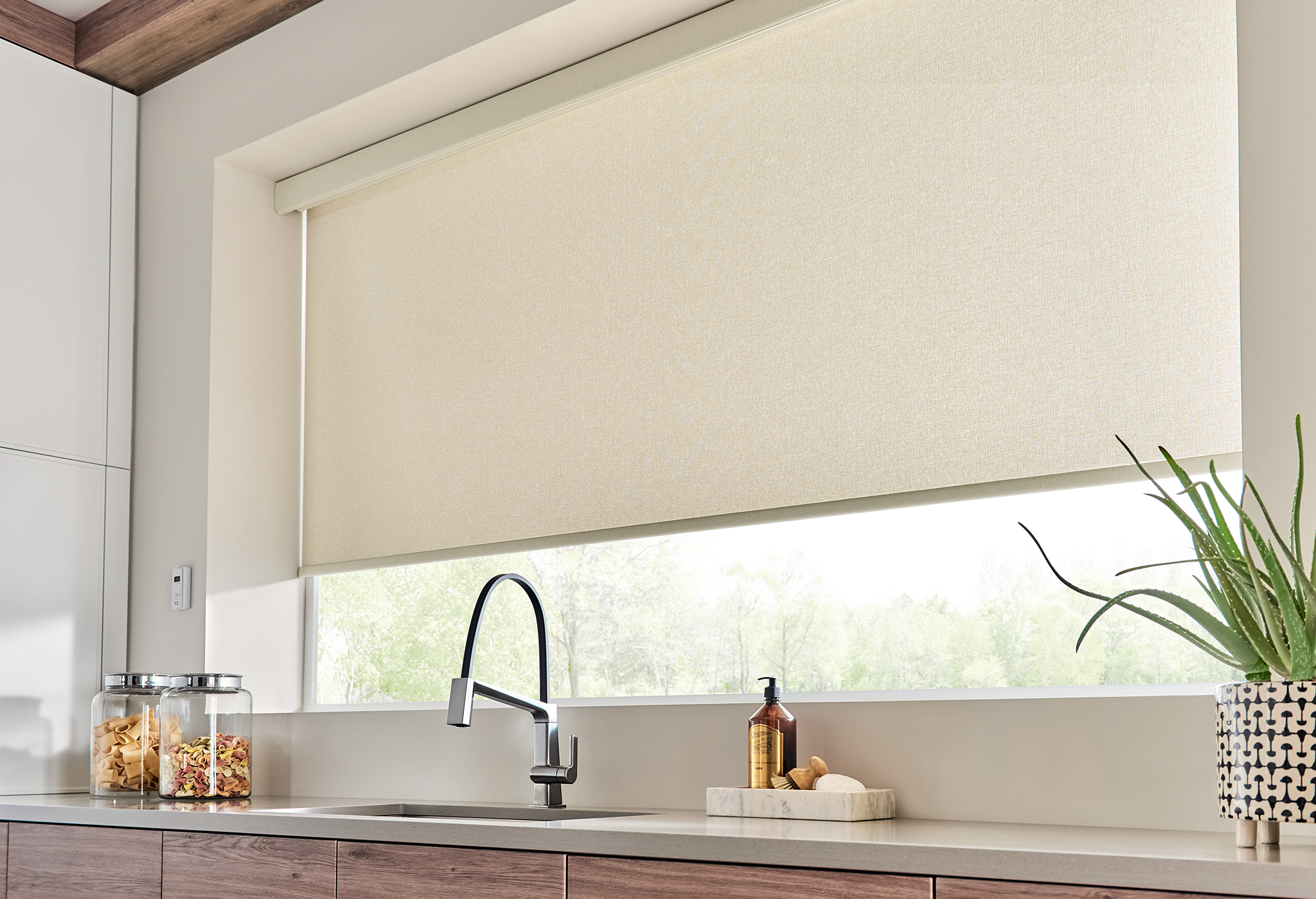 Solar shade in a living room with large windows and city view