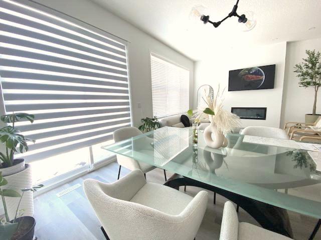 White zebra blinds in a modern living room showing alternating bands
