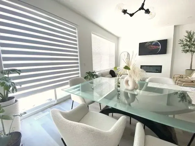 White zebra blinds in a modern living room showing alternating bands